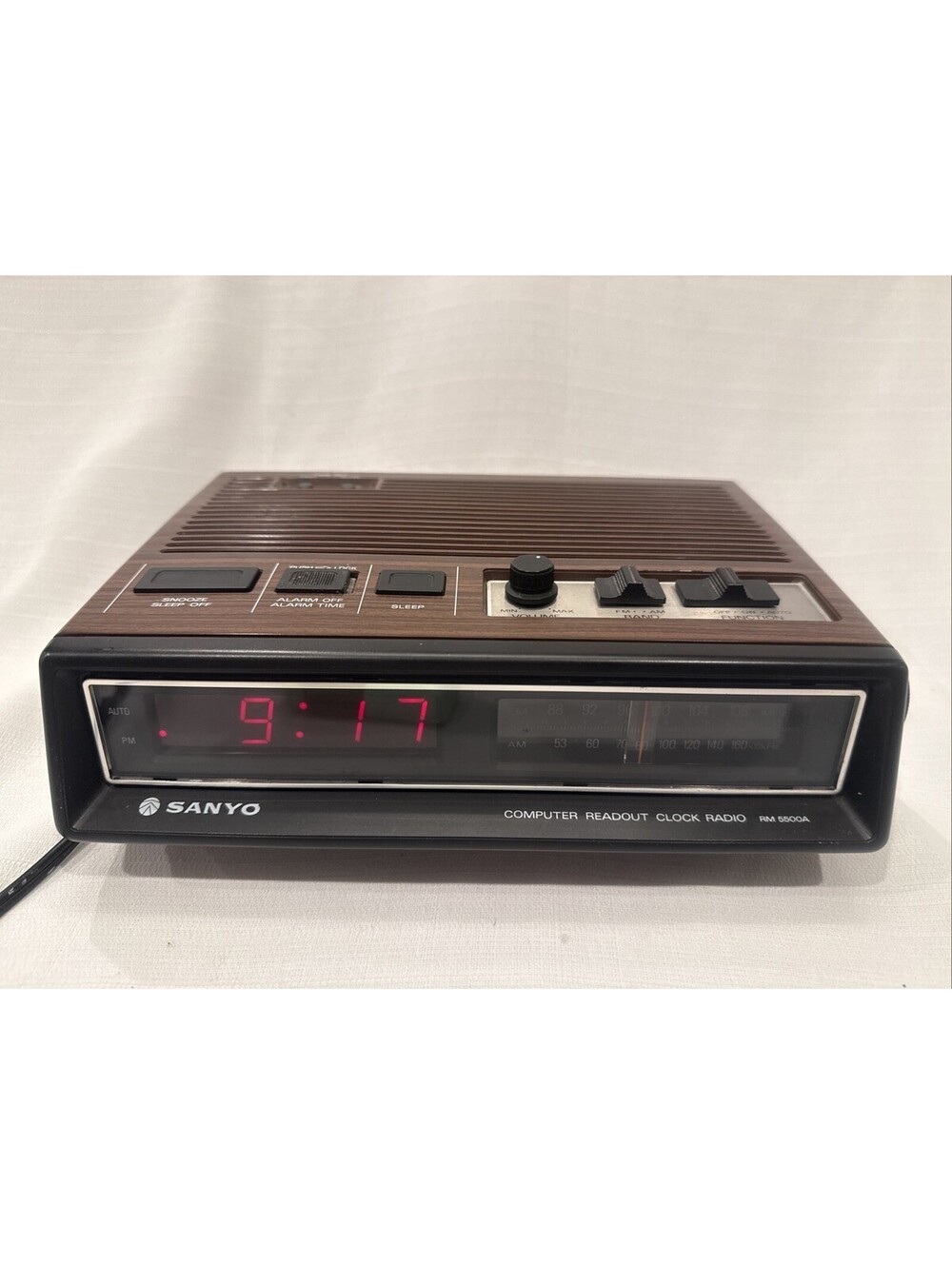 VINTAGE Sanyo Alarm Clock AM/FM Radio Wood Grain Model Number RM 5500A
